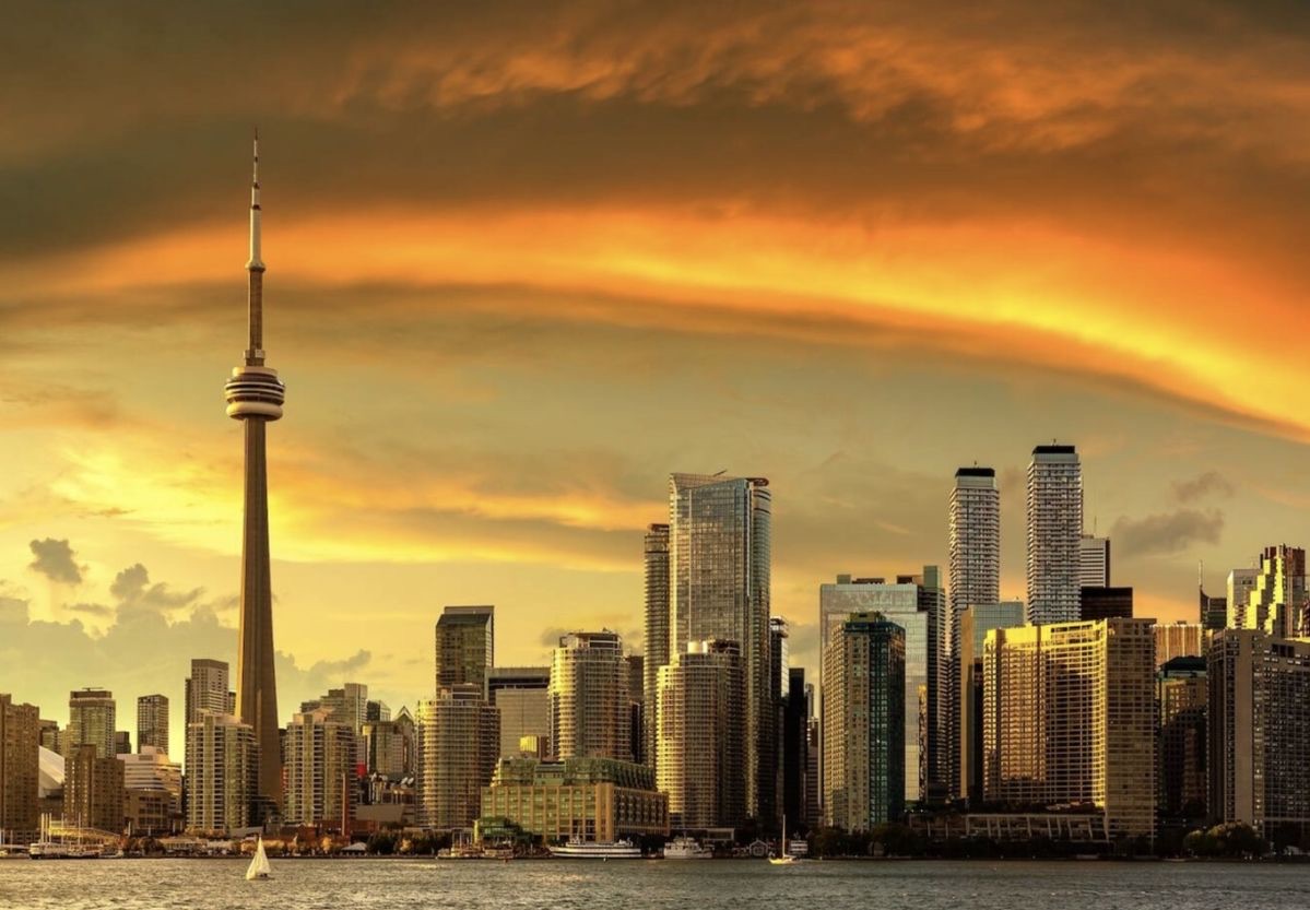 Toronto skyline under a glowing orange sky