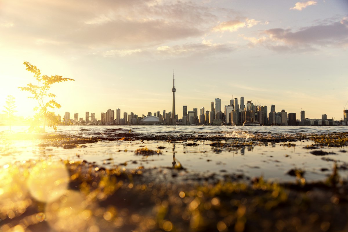 Golden sunrise over Lake Ontario with the Toronto skyline on the horizon